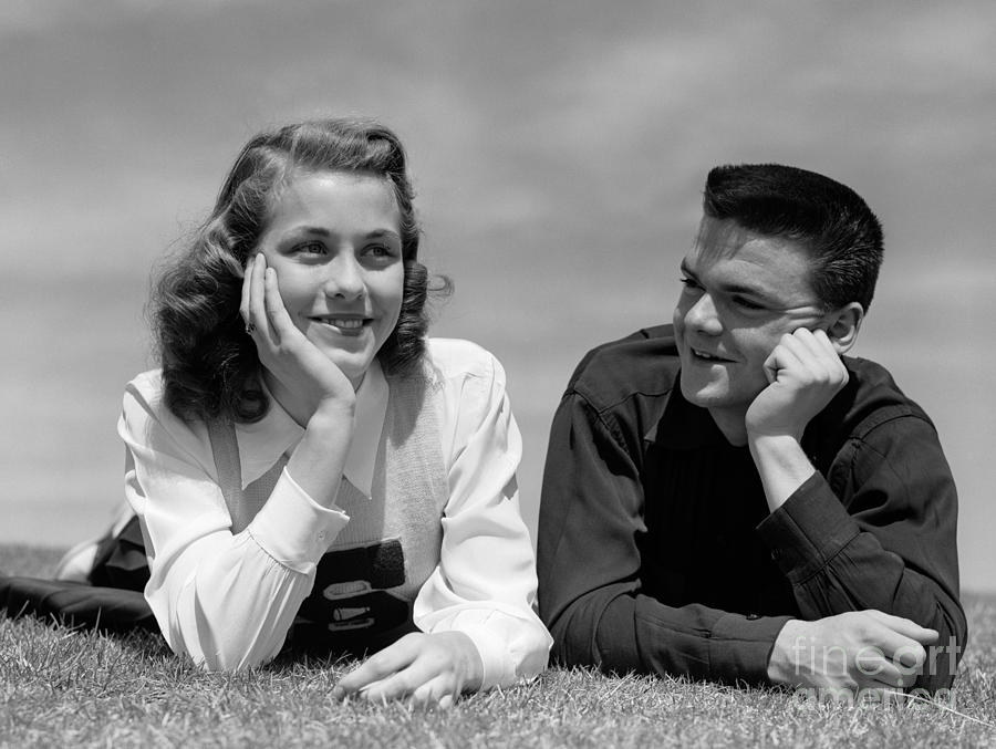 Teen Couple Lying In Grass, C.1950s Photograph by H. Armstrong Roberts/ClassicStock