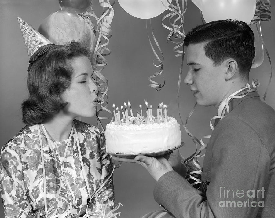 Cake Photograph - Teen Girl Blowing Out Birthday Candles by H. Armstrong Roberts/ClassicStock