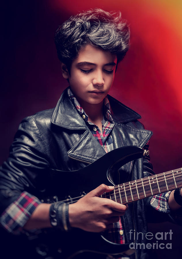 Teen guy playing on guitar Photograph by Anna Om