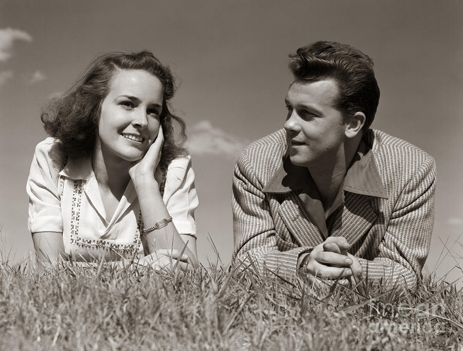 Teenage Couple Lying In Grass, C.1940s Photograph by H. Armstrong Roberts/ClassicStock
