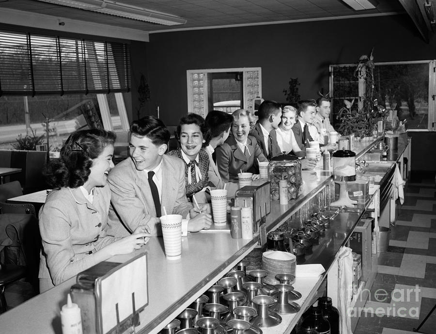 Fountain Photograph - Teens At Soda Fountain Counter, C.1950s by H. Armstrong Roberts/ClassicStock