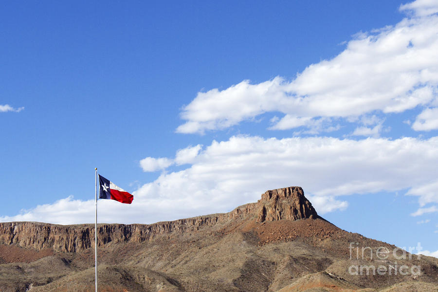 Texas State Flag with Blue Sky and Rock Mesa Photograph by Karen Foley