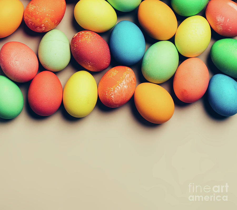Textured colorful eggs laying on the beige background. Photograph by Michal Bednarek
