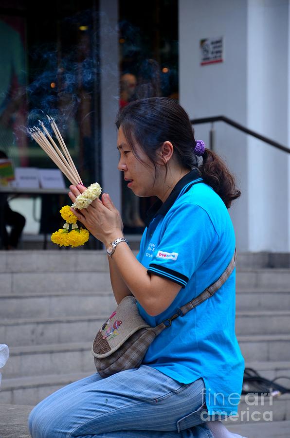 Thai woman worships and prays at outdoor shrine altar Bangkok Thailand Photograph by Imran Ahmed