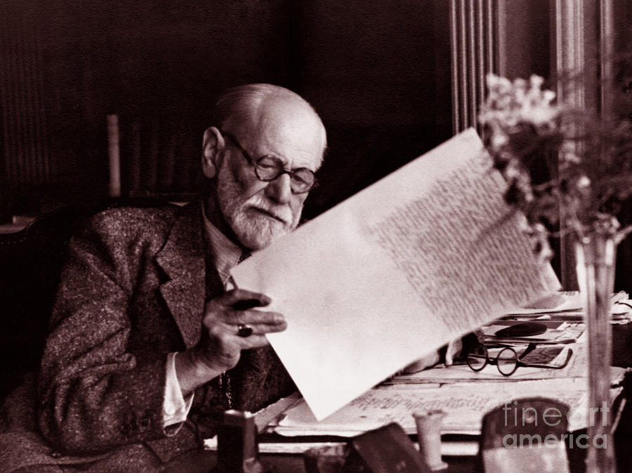 Flower Photograph - The Austrian neurologist Sigmund Freud at his desk by Austrian School