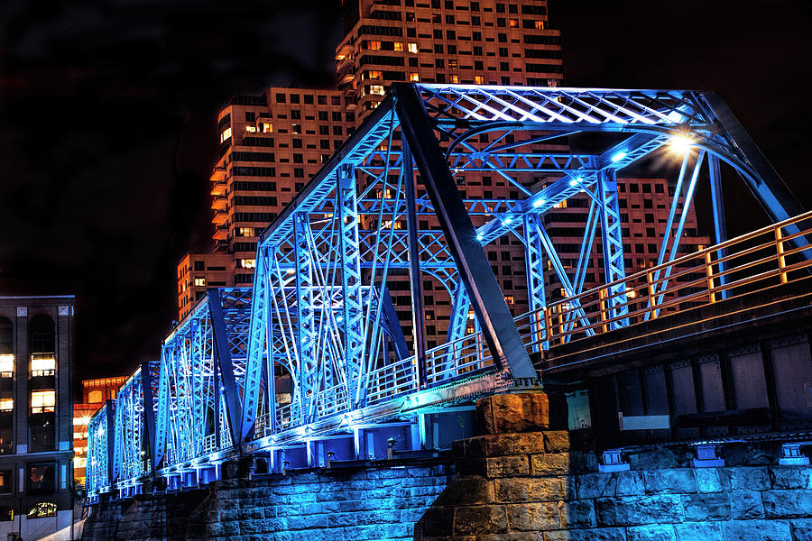 The Blue Walking Bridge from the River Bank Below at Night Photograph by Randall Nyhof
