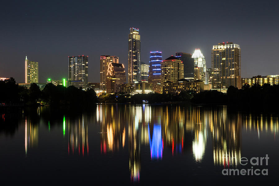 Austin Skyline Photograph - The glimmering Austin Skyline sparkles at night with a view from the Boardwalk Trail on Lady Bird Lake by Dan Herron