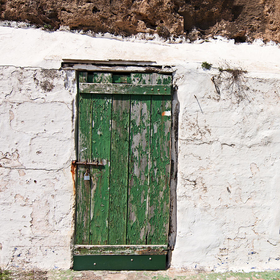 The green old door with peeling paint in a white wall Photograph by Pedro Cardona Llambias