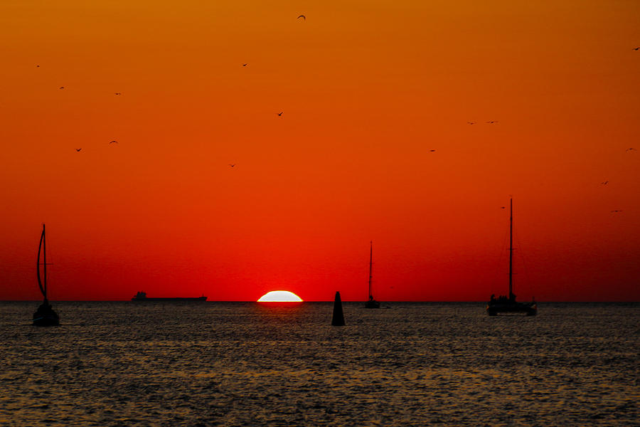 Sunset Photograph - The Last Moments by Peteris Vaivars
