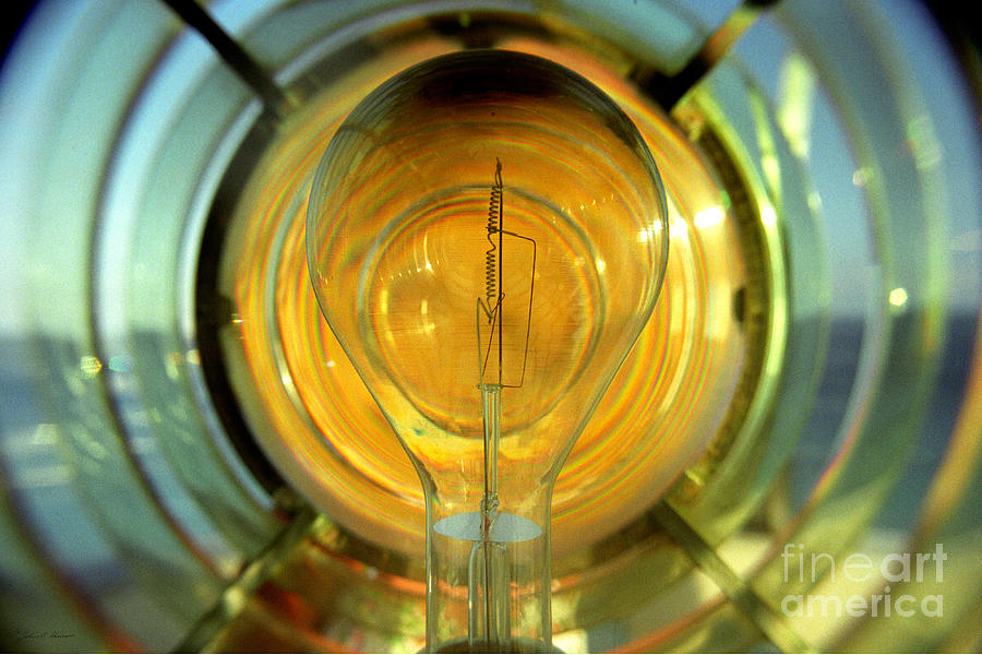 The light bulb inside the fresnel of a lighthouse Photograph by John Harmon