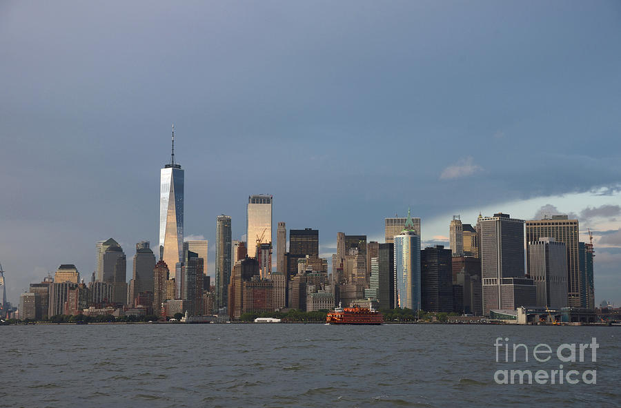   The Lower Manhattan Skyline Is Seen At Dusk With A Staten Island Ferry  In The Foreground.. Photograph by Tom Wurl