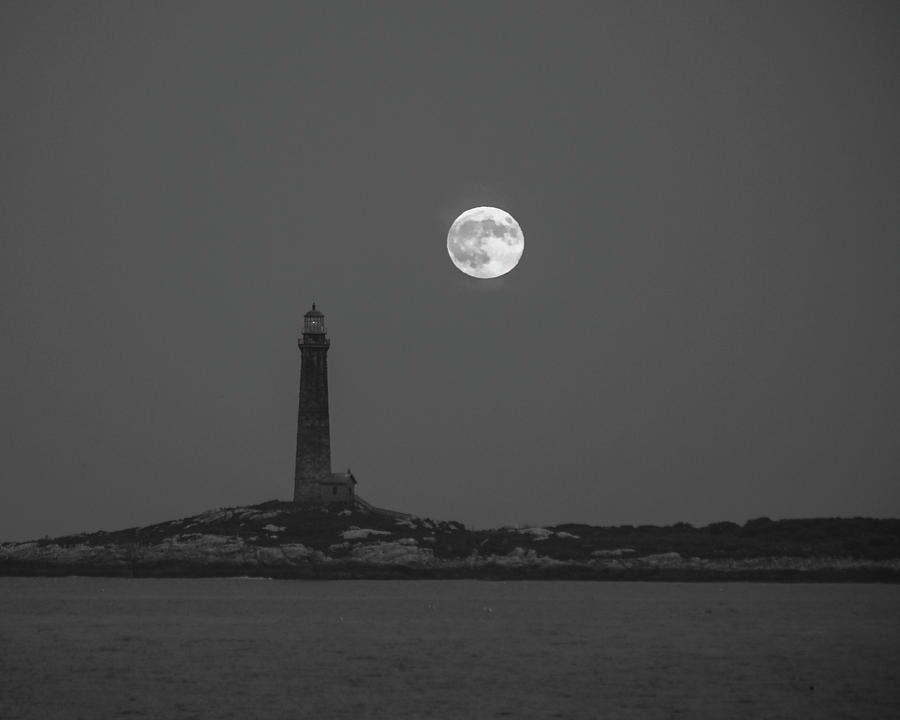 The moon rises over Thacher Island Lighthouse Rockport MA Black and White Photograph by Toby McGuire