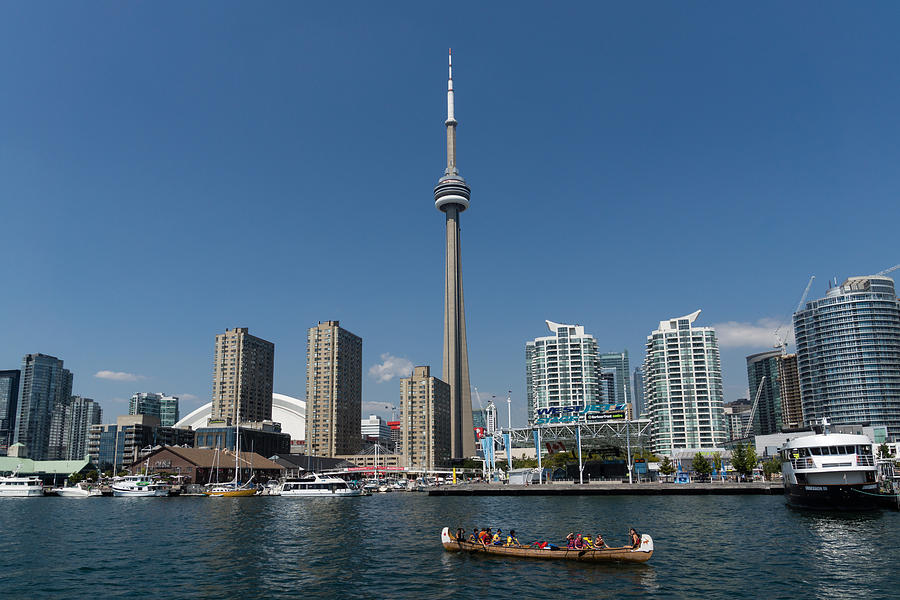 The Old and the New - Traditional Big Voyageur Canoe in Toronto Harbor Photograph by Georgia Mizuleva