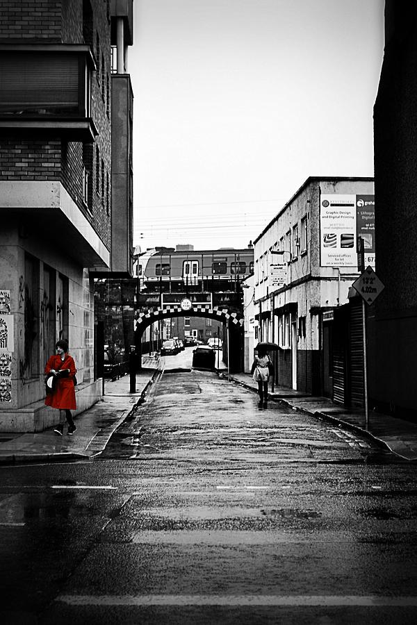 The Rail and the Red Raincoat Photograph by Nadalyn Larsen