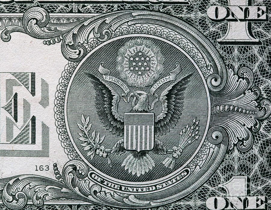Dollar Photograph - The Seal of The United States on the reverse side of one American dollar bill by Michal Bednarek