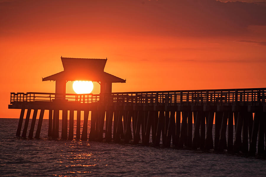 The sun has a hat Naples Pier Sunset Naples Florida Photograph by Toby McGuire
