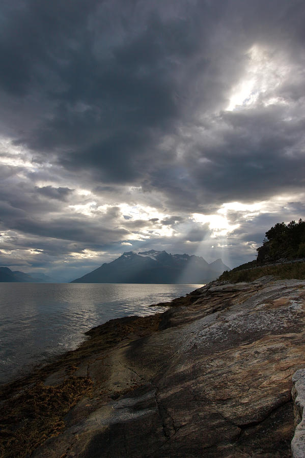 The Sun Is Shining Through Storm Clouds Over Salangen-fjord Photograph