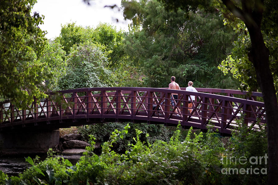 Runners Photograph - The Town Lake Hike and Bike Trail offers runners a paradise of lush green trails along Lady Bird Lake in Austin Texas by Herronstock Prints