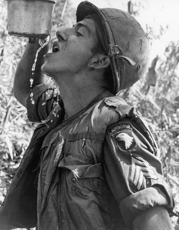 Vintage Photograph - Thirsty Vietnam Soldier by Underwood Archives