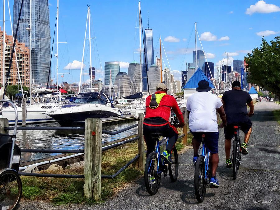 Three Bicyclists By Liberty Landing Marina Photograph by Susan Savad