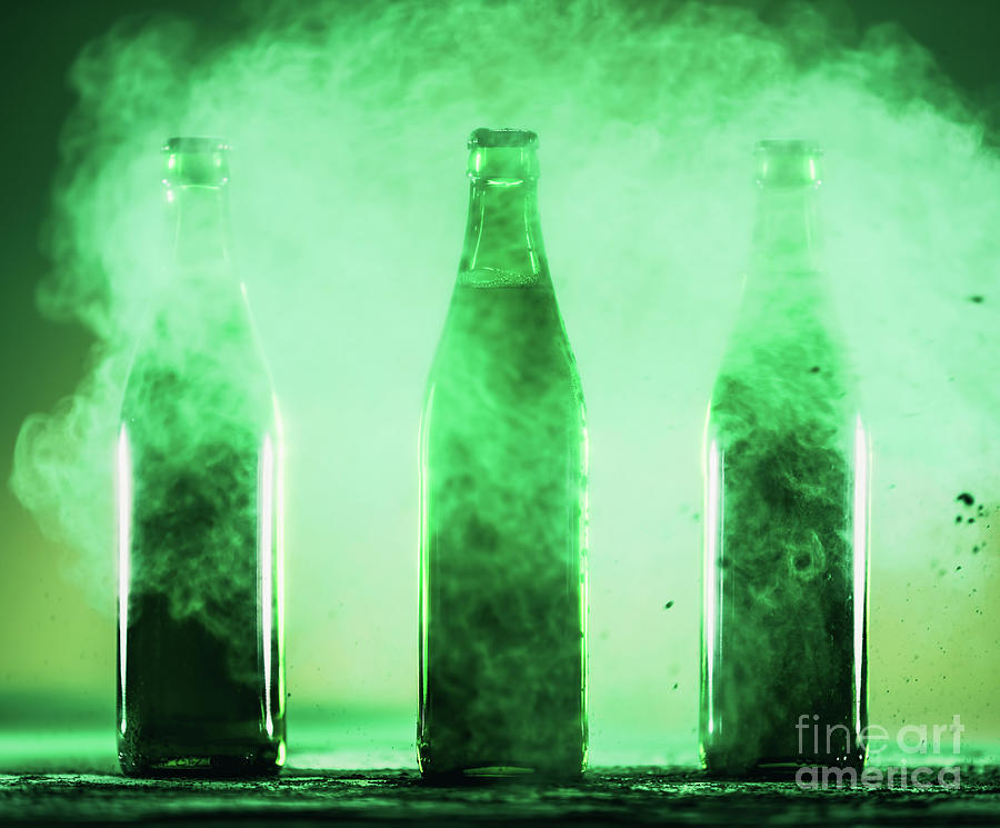 Three Green Bottles Standing In A Green Dust. Photograph
