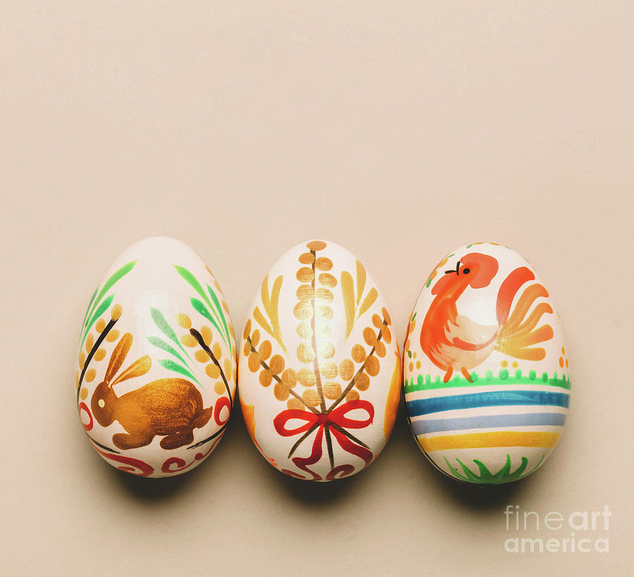 Three handmade Easter eggs on creamy background Photograph by Michal Bednarek