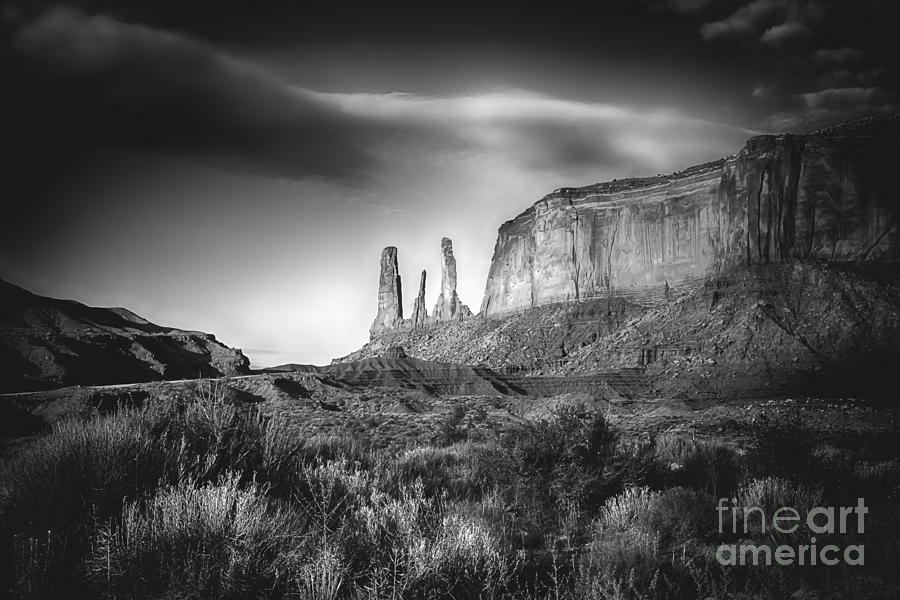 Black And White Photograph - Three Sisters Formation at Monument Valley by Priscilla Burgers