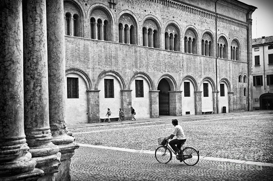 Black And White Photograph - Three walking one biking by Silvia Ganora