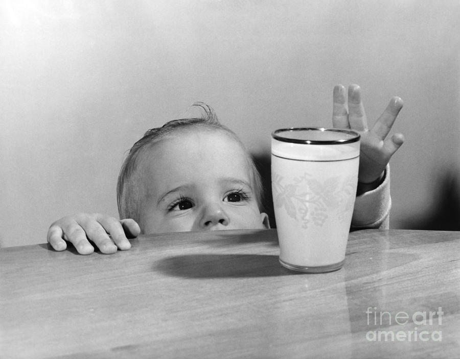 Vintage Photograph - Toddler Reaching For Glass Of Milk by O. Johnson/ClassicStock