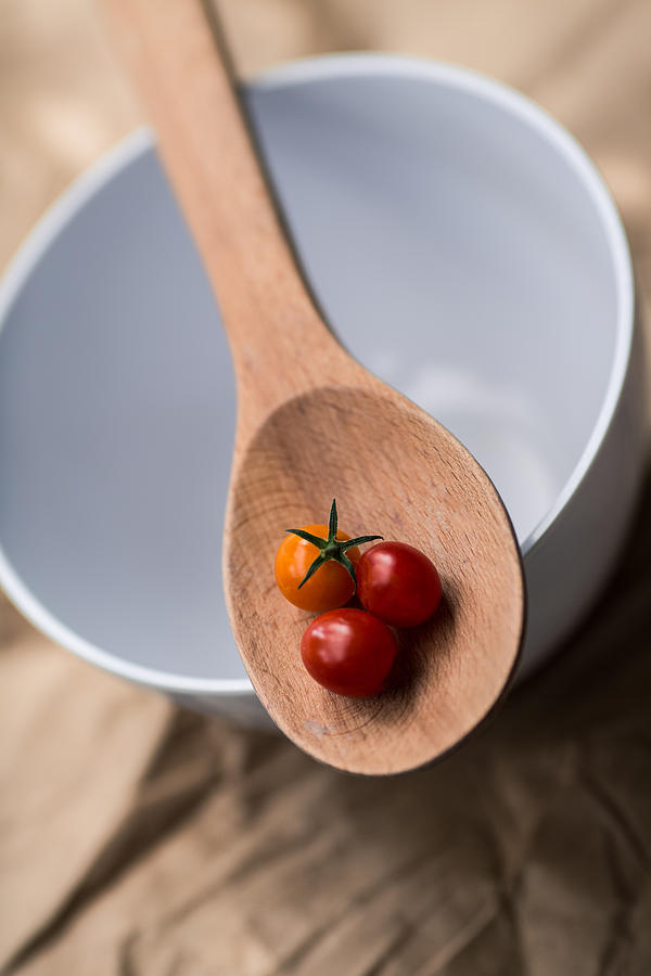 Tomatos on a Wooden Spoon Photograph by Rebecca Cozart