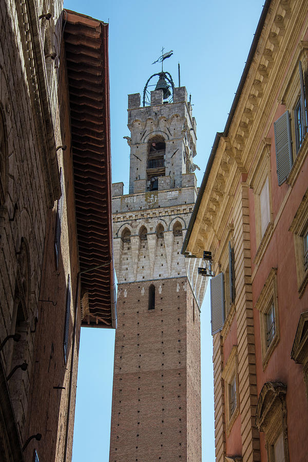 Torre del Mangia towering above of the Palazzo Pubblico Photograph by John McGraw