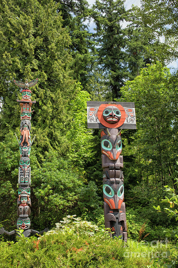 Animal Photograph - Totem poles in Vancouver, Canada by Patricia Hofmeester