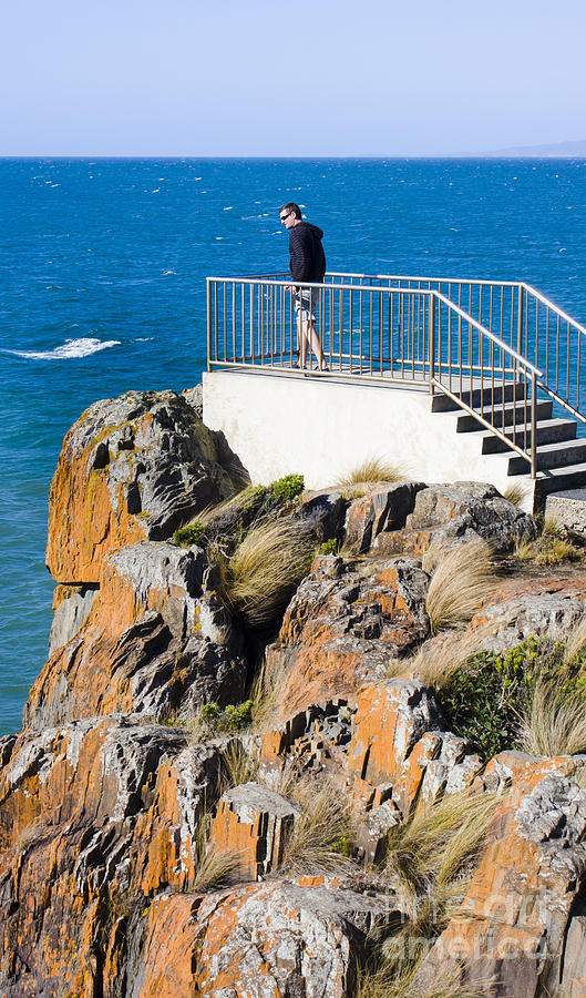 Tourist standing on the Mersey Bluff rock lookout Photograph by Jorgo Photography