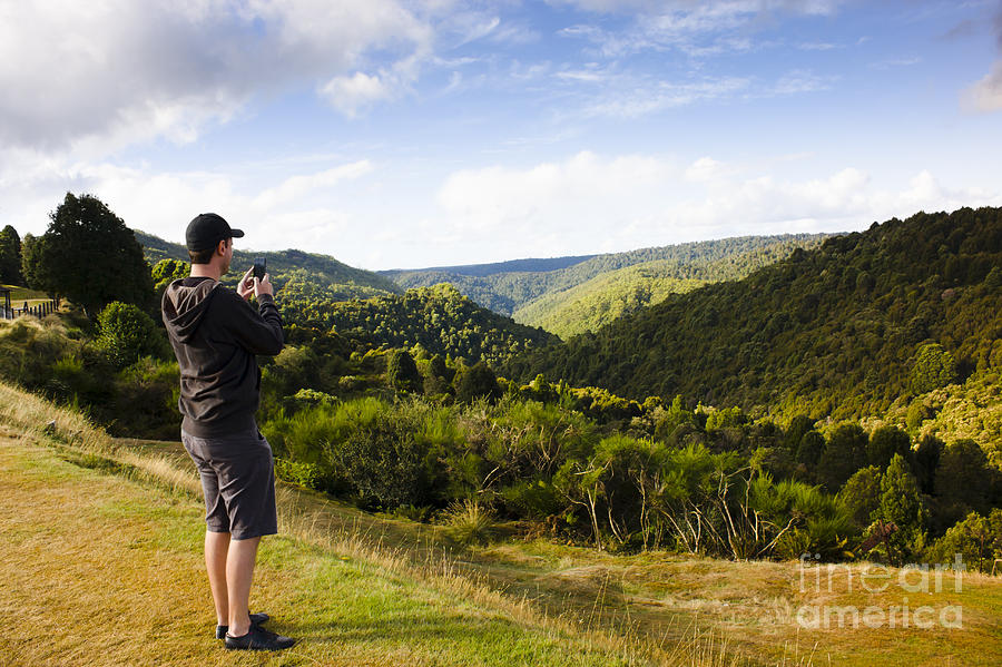Tourist taking landscape photo of North Tasmania Photograph by Jorgo Photography