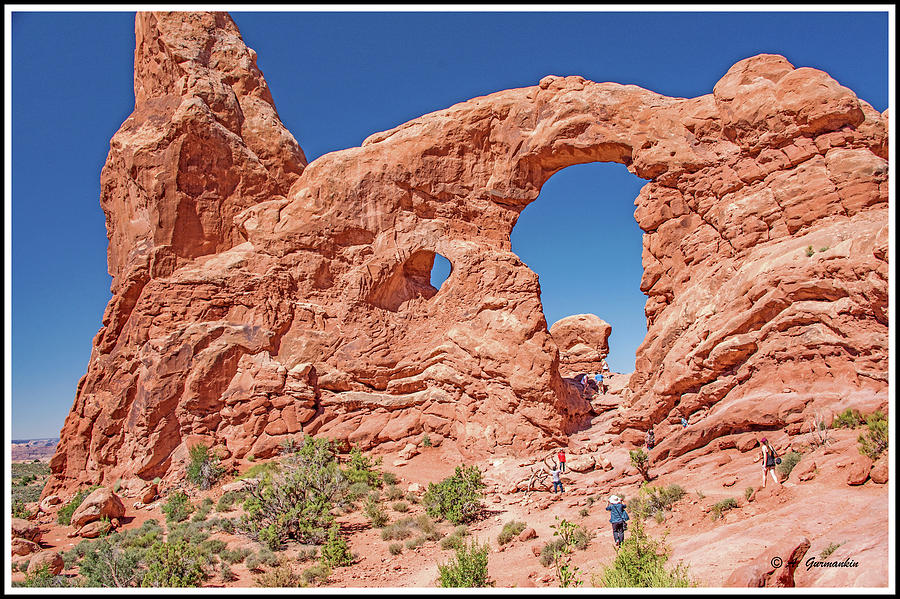Tourists on Sandstone Arch Formation, Arches National Park Photograph by A Macarthur Gurmankin