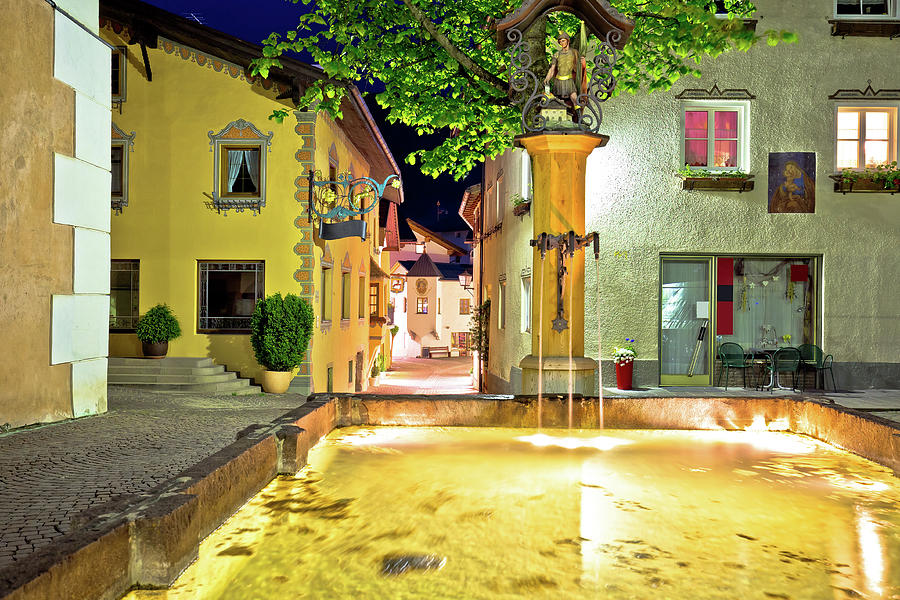 Town of Kastelruth fountain and street evening view Photograph by Brch Photography