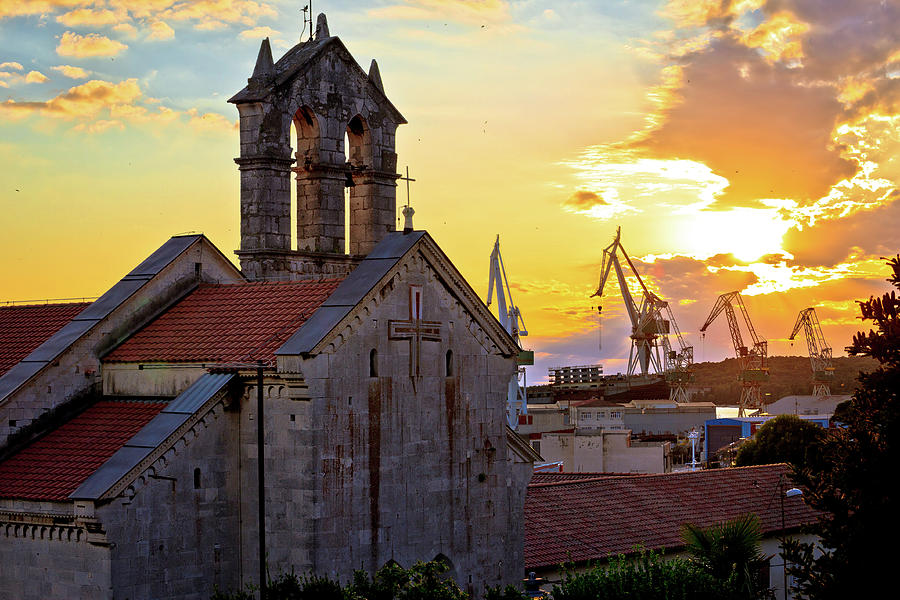 Town of Pula stone church and shipyard cranes sunset view Photograph by Brch Photography