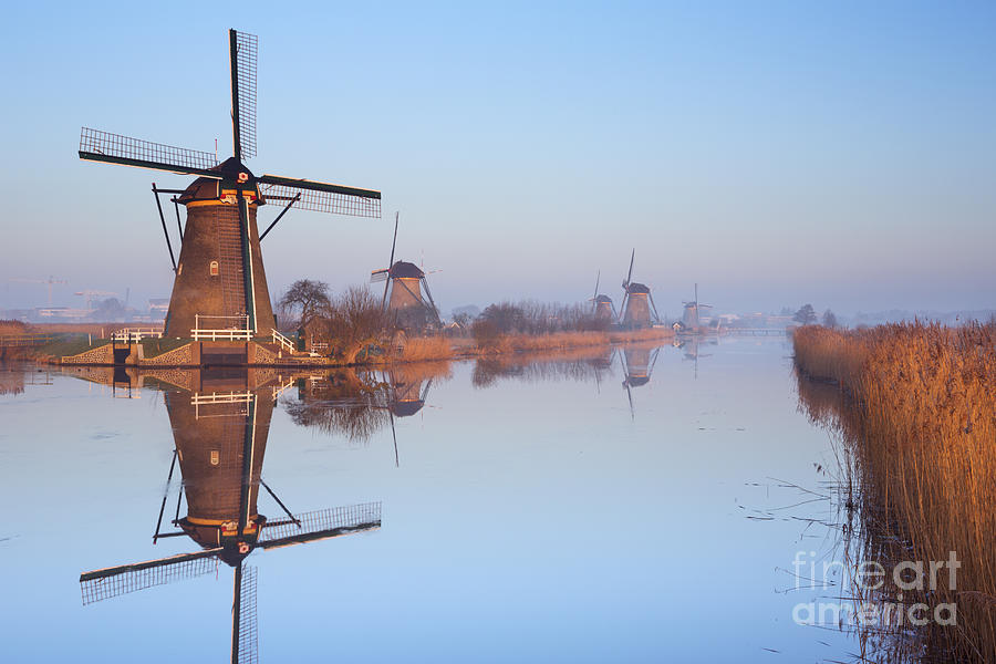Winter Photograph - Traditional Dutch windmills at sunrise in winter at the Kinderdi by Sara Winter