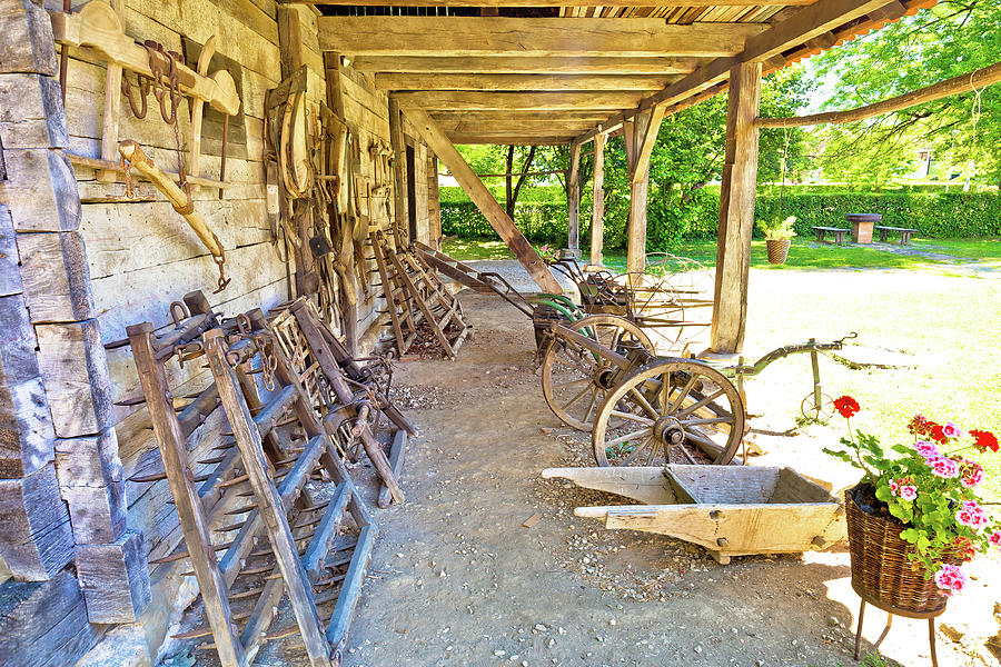 Traditional wooden cottage and agricultural tools in rural regio Photograph by Brch Photography