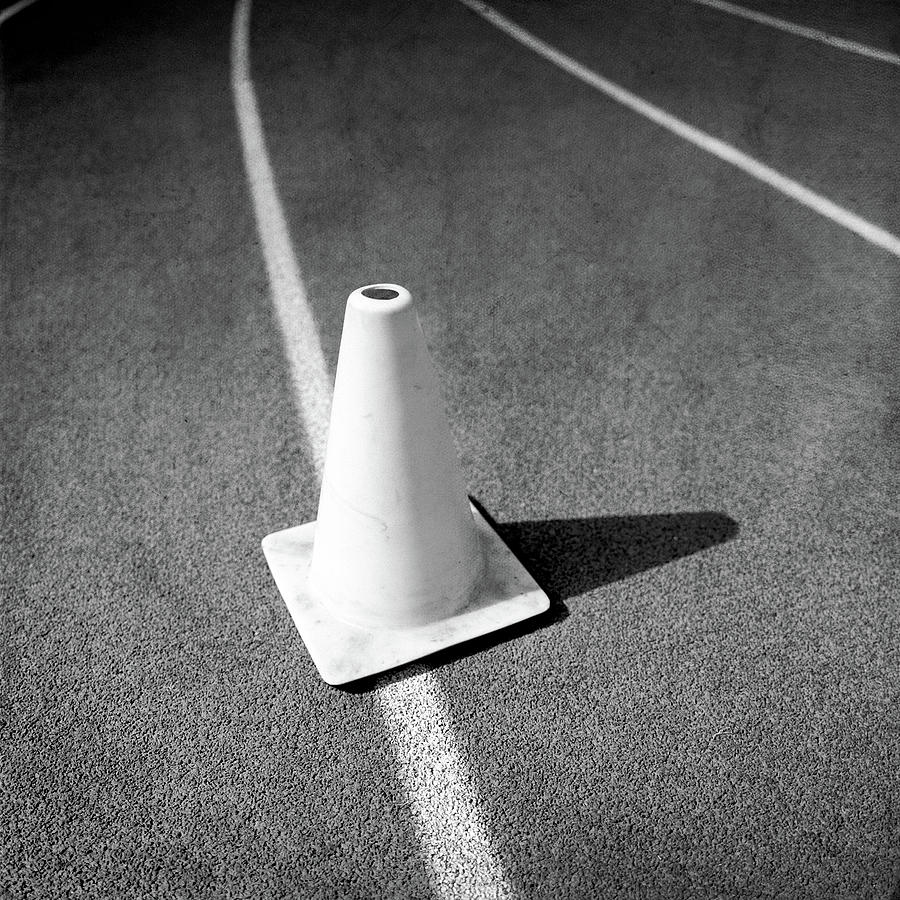 Traffic Cone On Runners Track Lanes In Bw Photograph