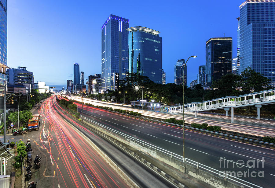 Traffic light trails in Jakarta business district in Indonesia c Photograph by Didier Marti