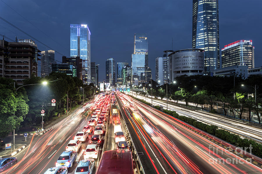 Traffic light trails in the heart of Jakarta business district i Photograph by Didier Marti