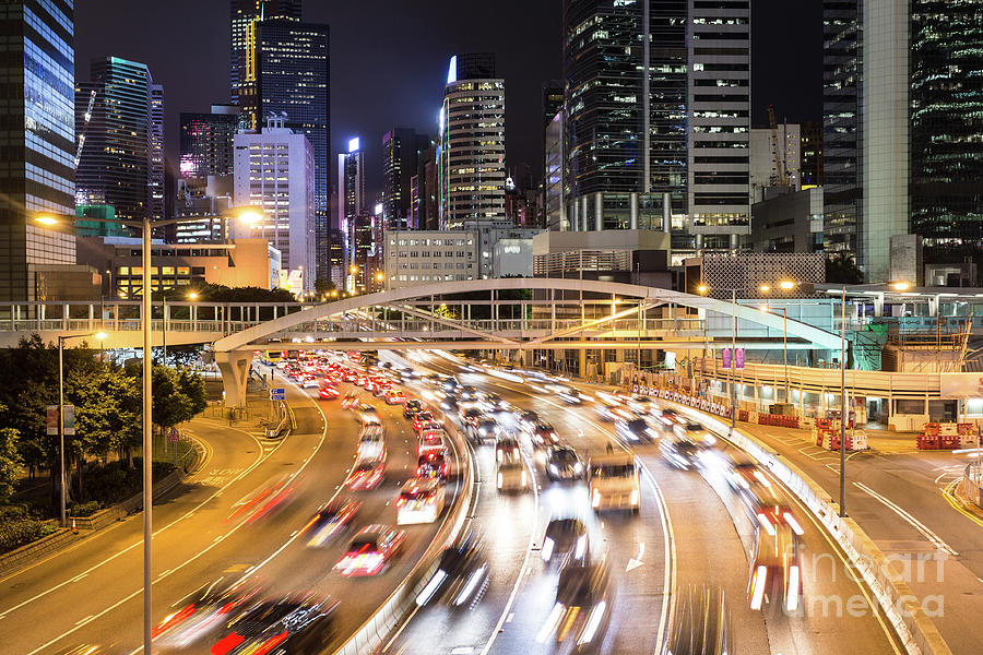 Traffic rushing in in the Central business district in Hong Kong Photograph by Didier Marti