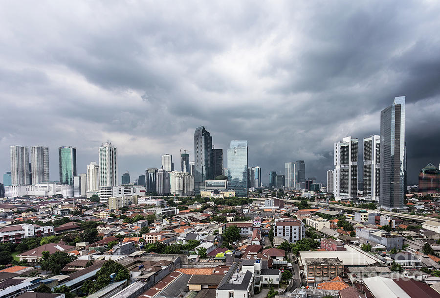 Tropical storm coming over Jakarta business district in Indonesi Photograph by Didier Marti
