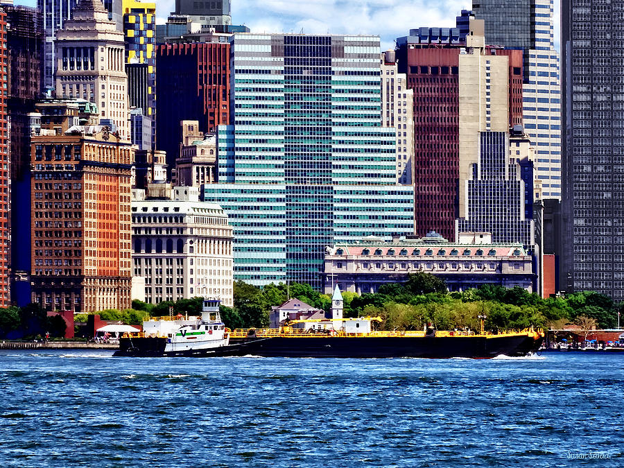 Skyscraper Photograph - Tugboat Pushing Barge Near Manhattan Skyline by Susan Savad