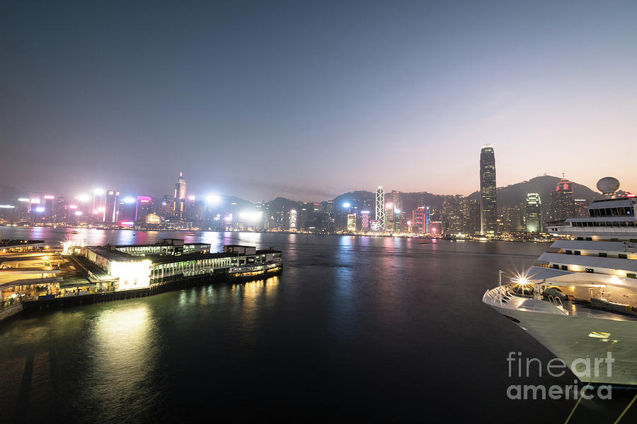Twilight over the Victoria harbor and star ferry terminal in Hon Photograph by Didier Marti