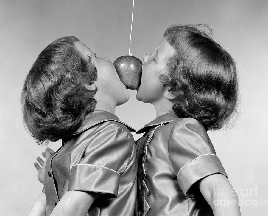 Twin Girls Bobbing For Apple Photograph by H. Armstrong Roberts/ClassicStock