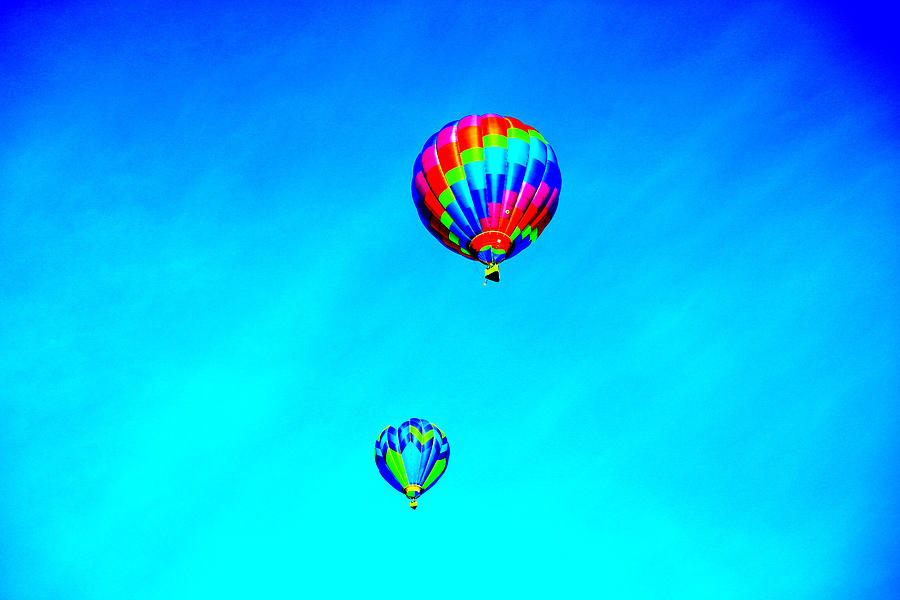 Two balloons in the blue sky Photograph by Jeff Swan