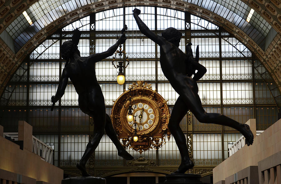 Two bronze sculptures framing great Gold Clock Orsay Museum Great Hall Paris France Photograph by Shawn OBrien