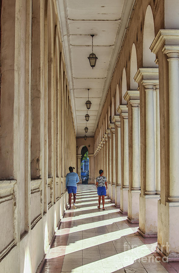 Two girls walking in an arched hallway Photograph by Patricia Hofmeester